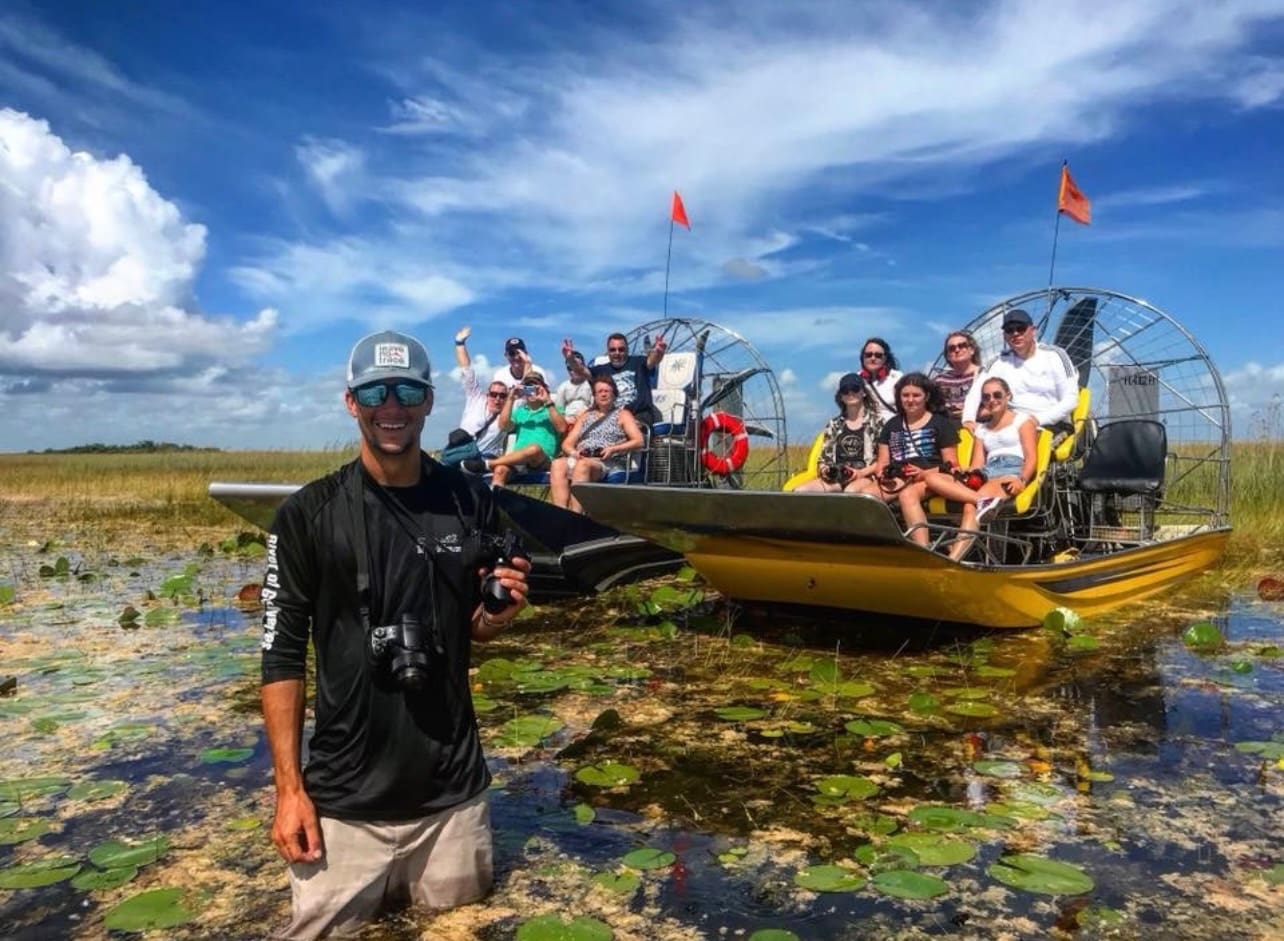 Group on airboat tour in marshland.